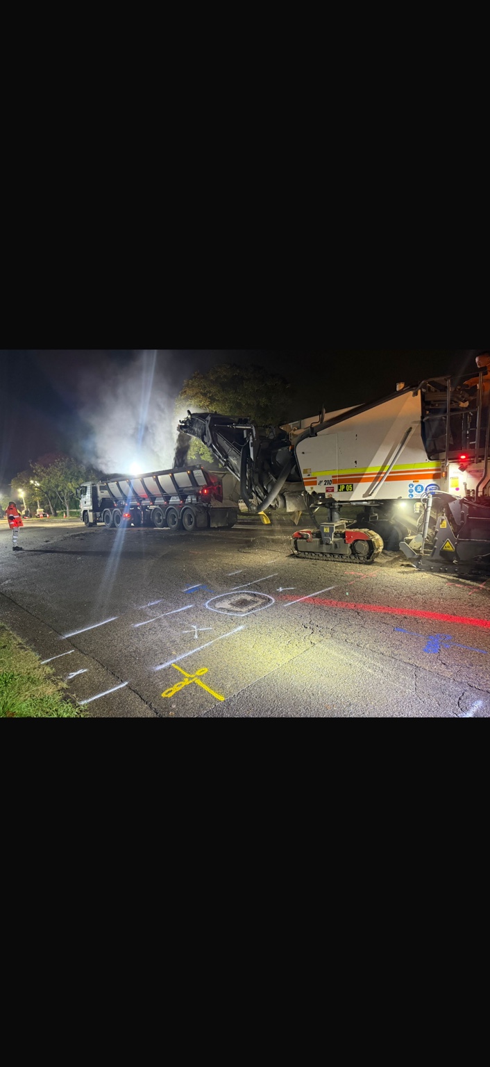 Road milling machine operating at night